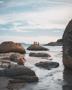 Rocks on beach against sky