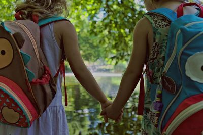 Rear view of women standing outdoors