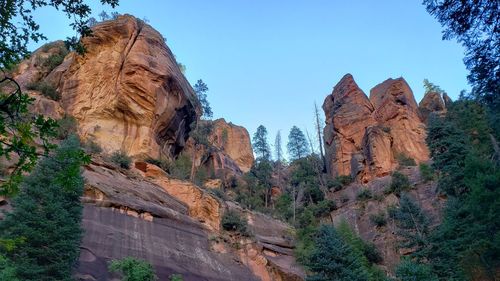 Low angle view of rock formations against sky