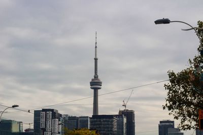 Low angle view of buildings against cloudy sky