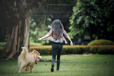 Rear view of woman with dog