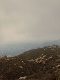 Scenic view of mountains against cloudy sky