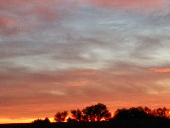 Scenic view of dramatic sky at sunset