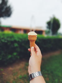 Close-up of hand holding ice cream cone