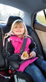 Portrait of girl sitting on seat