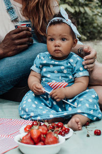 Cute baby girl sitting with ice cream