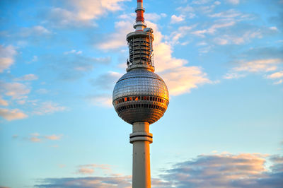 Low angle view of communications tower against sky