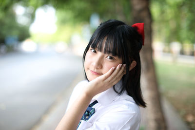 Portrait of young woman standing outdoors