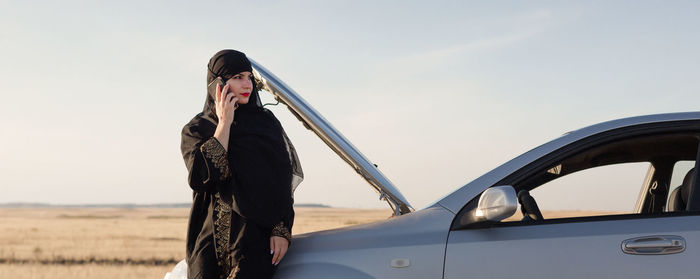 Islamic woman taxi driver driving a car., person