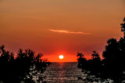 Scenic view of sea against romantic sky at sunset