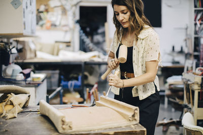 Female entrepreneur making furniture at workshop