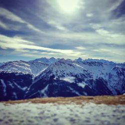 Scenic view of snowcapped mountain against cloudy sky