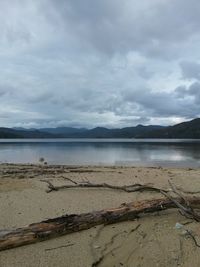 Scenic view of lake against cloudy sky