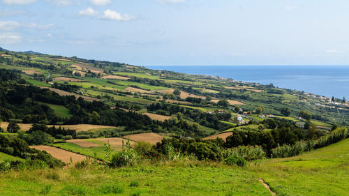 Scenic view of landscape and sea against sky