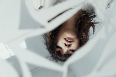 High angle portrait of woman lying on bed