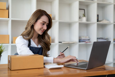 Young woman using laptop at office