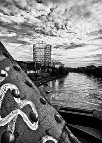 Pier on sea against cloudy sky