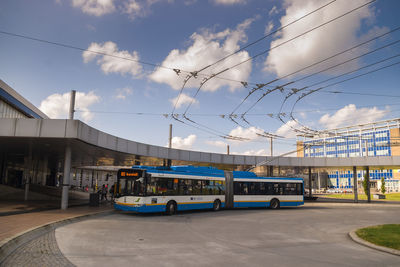 Cars on street in city against sky