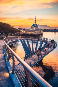 Bridge over river during sunset