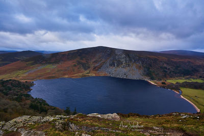 Scenic view of lake and mountains against sky