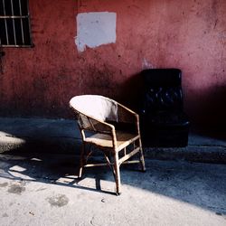 Empty chairs and table in abandoned building