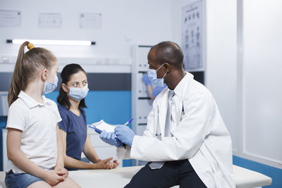 Female doctor examining x-ray at clinic