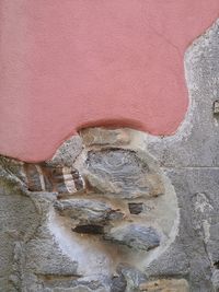 Close-up of old sculpture against wall