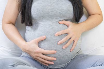 Midsection of woman suffering from knee pain