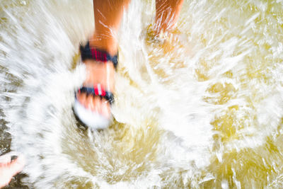 Blurred motion of person surfing in river