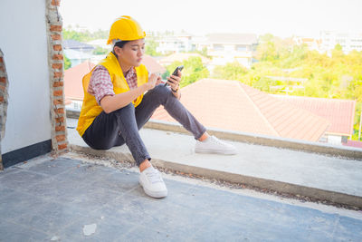 Side view of young man using mobile phone