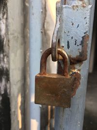 Close-up of padlock on rusty metal