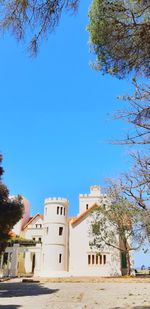 Low angle view of buildings against blue sky