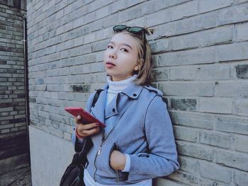 Portrait of girl holding mobile phone