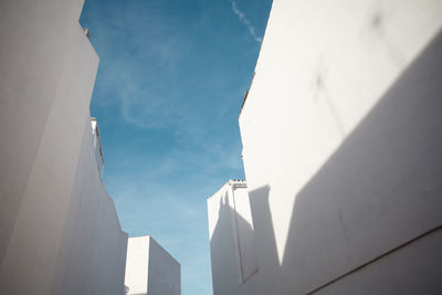 Low angle view of white buildings against sky