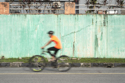 Side view of man riding bicycle