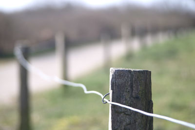 Close-up of wooden post on fence