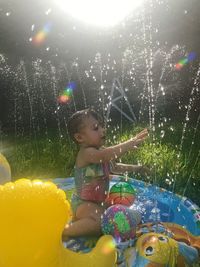 Full length of cute boy against water