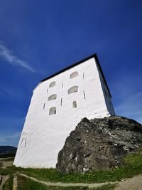 Low angle view of building against blue sky