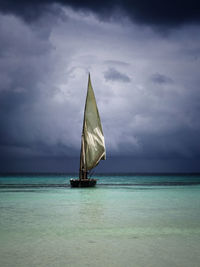 Sailboat in sea against sky