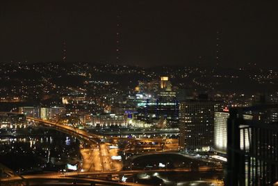 Aerial view of city lit up at night
