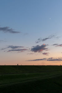 Scenic view of field against sky during sunset