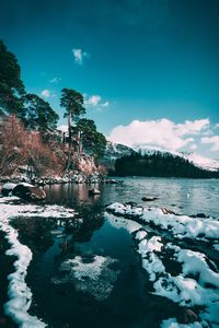 Scenic view of lake against sky during winter