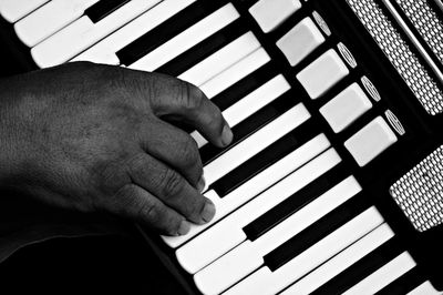 Close-up of hands playing piano