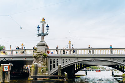 Arch bridge over river in city