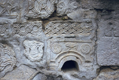 Close-up of sculpture on stone wall