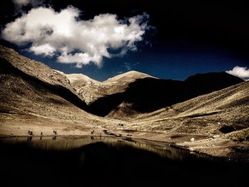 Scenic view of snowcapped mountain against cloudy sky