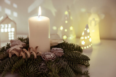 Close-up of illuminated candles on table