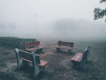 Empty bench in park during rainy season