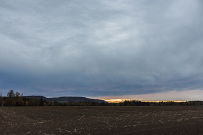 Scenic view of field against sky during sunset