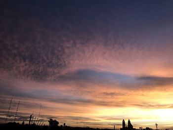 Low angle view of silhouette buildings against sky during sunset